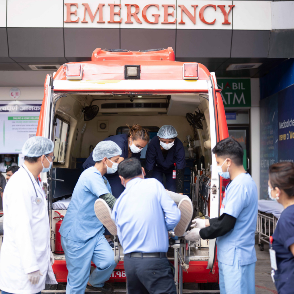 a group of people in scrubs and face masks getting into an ambulance